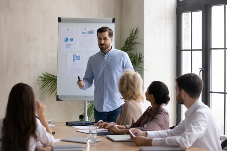 Businessman making a presentation with charts to a group of other professionals